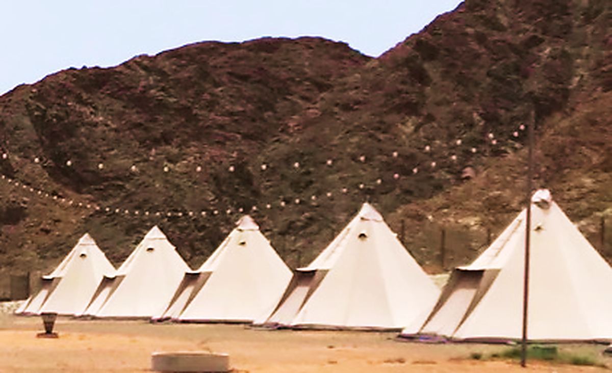 A long dining set-up running through the camp
