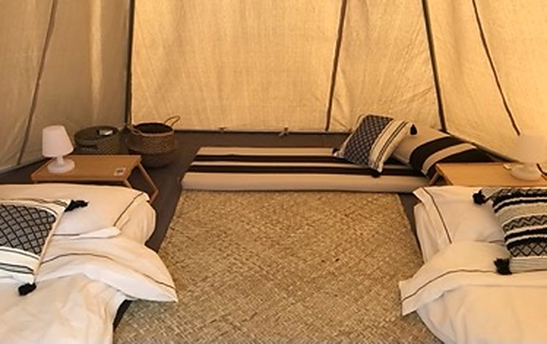 Beds made up inside a teepee